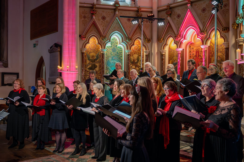 Horizons choir performing by candlelight in a Bath church